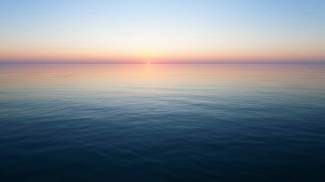 Peaceful ocean sunset with calm waters.