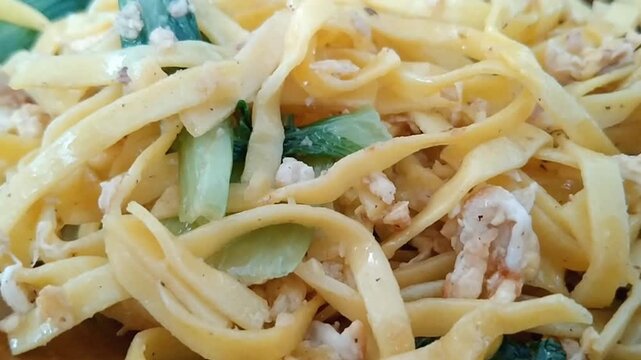 Indonesian fried noodles or mie goreng with shredded chicken egg and bok choy