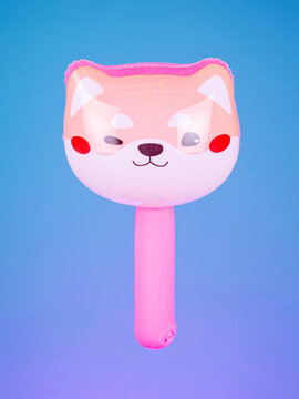 Close-up of an inflatable stick with a corgi dog head on a purple background. Bright, cute, and perfect for fun photos and playful moments.