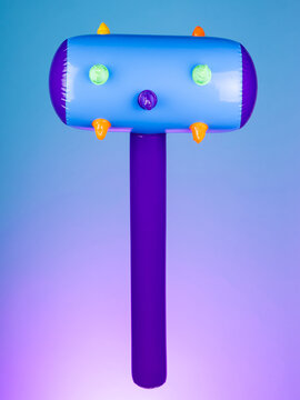 Close-up of an inflatable mace with spikes on a purple background, emphasizing its rugged and bold design&mdash;perfect for playful battles or quirky decor