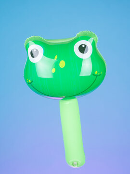 Close-up of an inflatable stick with frog-shaped inflatables on a purple background, highlighting its playful and fun design.