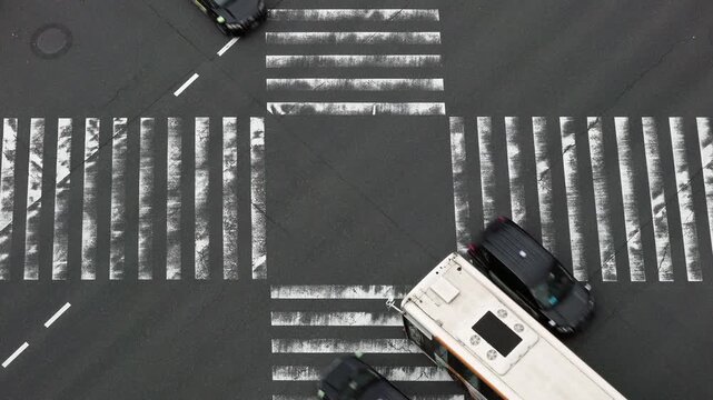 Tokyo Scene  :  Bird's-eye View of Vehicles Crisscrossing the Intersection, a Route Bus Turning Right, Faded White Lines Bearing Witness to the Heavy Traffic  |  Tokyo, Japan