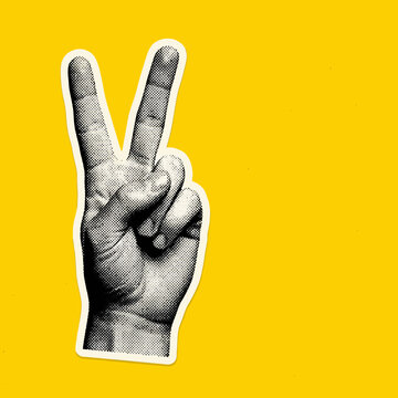 A retro halftone peace sign hand sticker on a yellow background