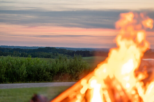 Traditional Latvian Midsummer Bonfire Prepared for Jāņi and Līgo Celebration in Rural Landscape
