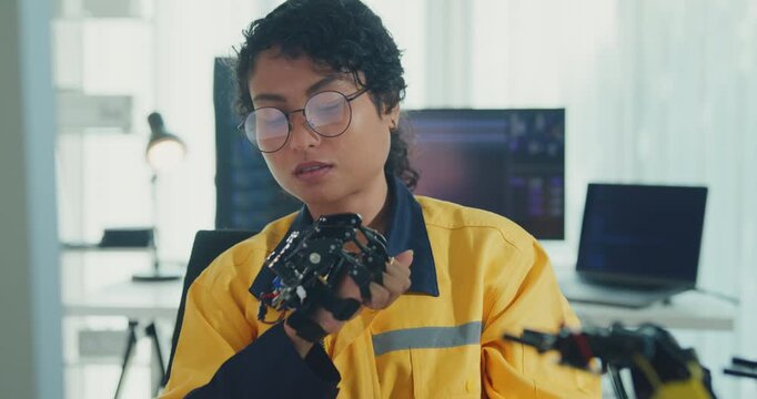 Young Black female engineer coding AI robot arm in modern laboratory. Robotics, artificial intelligence, technology, stem, future, innovation, diversity, automation, machine learning concept.