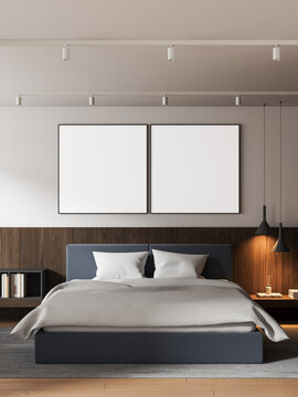 Modern bedroom interior with clean design featuring two blank poster mockups above a neatly arranged bed in soft light creating spacious calm atmosphere. 3D Rendering