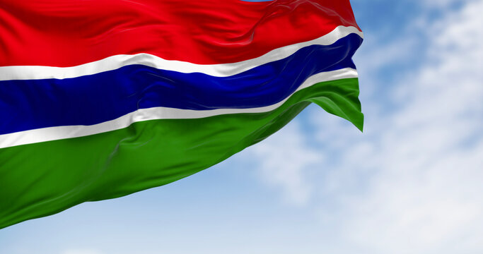 National flag of the Gambia waving in the wind on a clear day