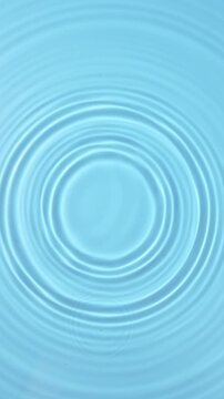 blue water drop falling down in slow motion, water ripples background.	