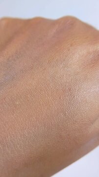 Close up of hands applying moisturizing lotion to treat dry skin and improve hydration in a daily beauty routine.