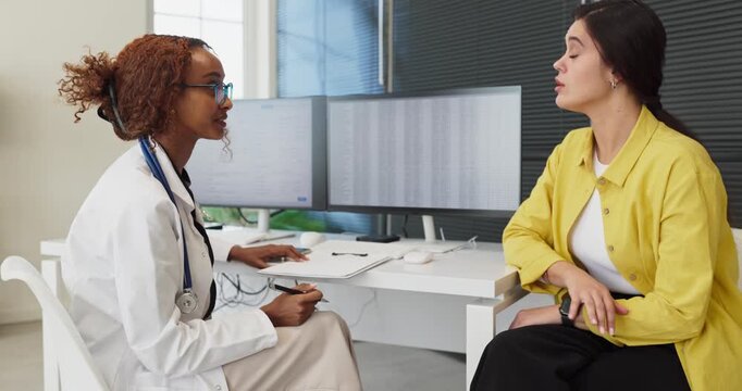 Doctor patient consultation at clinic healthcare appointment. The physician reviews records, offers diagnosis and advice through conversation. Essential concept of professional healthcare.