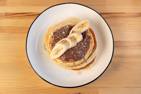 Banana pancakes with chocolate topping top view 