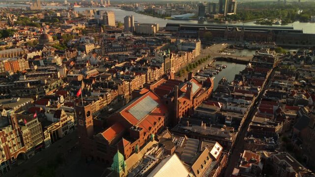 Drone flies forward toward Amsterdam Central Station and the IJ waterfront revealing the historic canal city from above