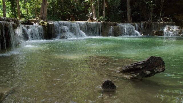 Clear Flowing Water Cascades Over Rocky Tiers Into A Turquoise Forest Pool At Huai Mea Khamin Waterfall In Kanchanaburi Thailand