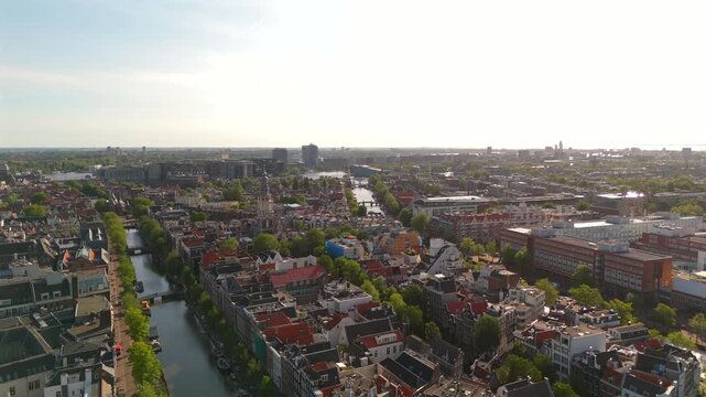 360 drone panorama above Amsterdam parallel historic canals with tree-lined embankments and canal houses