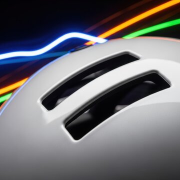 White Bicycle Helmet with Colorful Light Trails in Dark Background