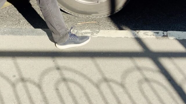 People wait patiently at a sunny bus stop in Simferopol, Crimea. The long morning shadows create a calm, expectant feeling as they look forward to their journey.