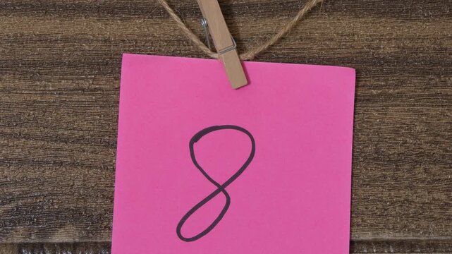 Fuchsia Post-it note with the number eight