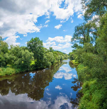 pictorial wild landscape Schwarzer Regen river with reflecting clouds and blue sky, viechtach
