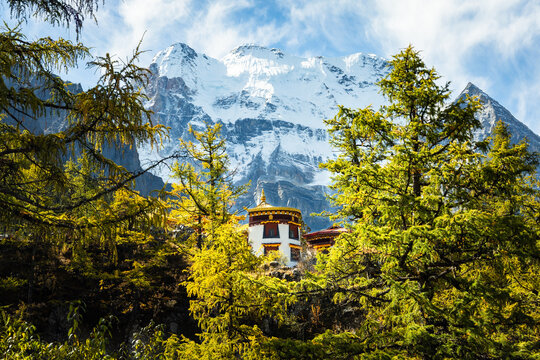 Chongu Temple with snow mountain in the background in Yading Nature Reserve, Sichuan, China