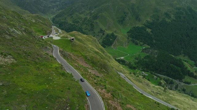 Beautiful aerial view of a car exploring the Timmelsjoch High Alpine Road in Austria surrounded by majestic alpine mountains scenic landscapes and tourism