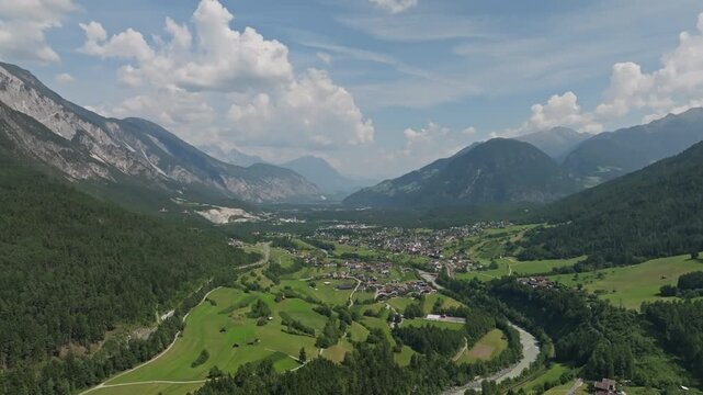 Aerial view of alpine villages in the valleys of Tyrol Austria surrounded by majestic mountain peaks dense forests and breathtaking landscapes for travel in Europe