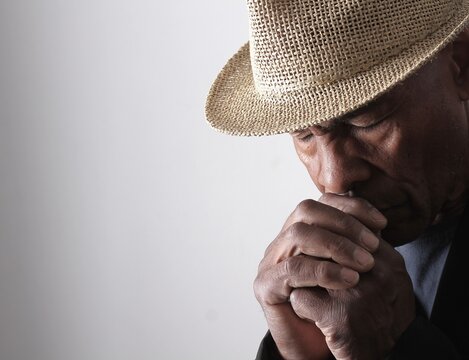 A serene portrait of a man praying with hands together in deep prayer that perfectly captures themes of faith, hope, mindfulness, and inner peace stock image stock photo