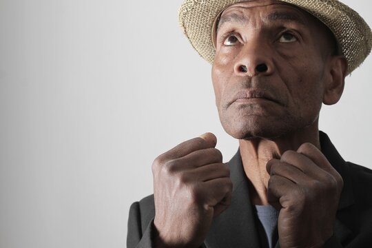A serene portrait of a man praying with hands together in deep prayer that perfectly captures themes of faith, hope, mindfulness, and inner peace stock image stock photo