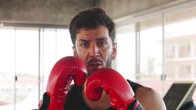 Man Throwing Boxing Punch During Gym Workout