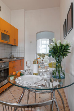 Staged Glass Dining Table with White Roses and Wine