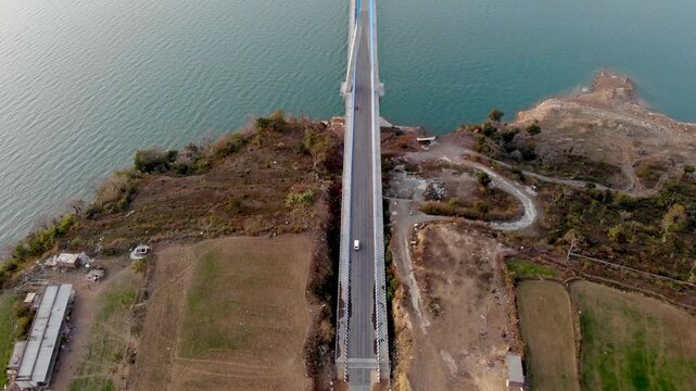Drone shot of Atal Setu bridge towering over Ranjit Sagar Dam reservoir.