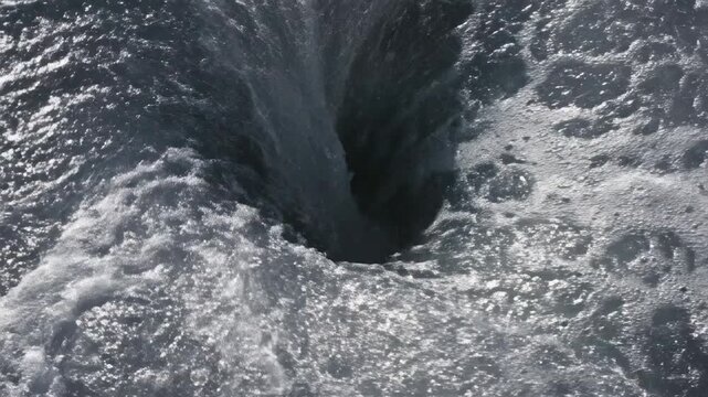 Powerful Water Vortex Churning into Dark Hole ideal for nature or environmental concepts.