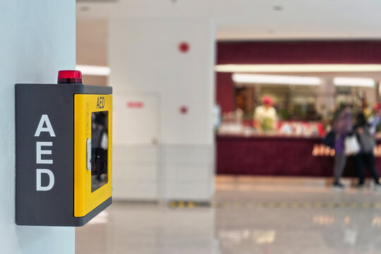 AED or Automated external defibrillator for heart attack first aid made available in public shopping center strategic location for emergency use. Attached to a wall, it can be easily reached.
