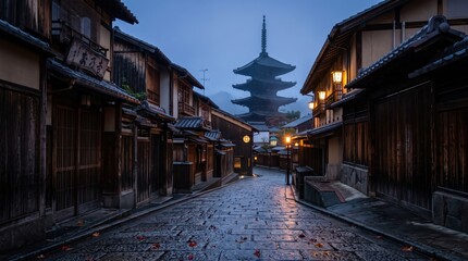 Naklejka premium Empty historic wooden street with cobblestone pavement leading to multi tiered pagoda, lanterns glowing in damp dusk atmosphere after rain, quiet traditional district