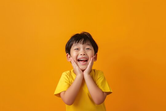 Asain kid hands cupping face happy surprised person.