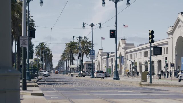 The Embarcadero Street Level SUVs Passing Near Ferry Building Sunny - Wide Shot