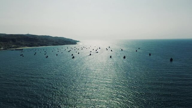 Wide Drone View of Fishing Boats on Pacific Ocean in Ecuador, Coastal Hills, Shimmering Water and Tropical South American Seascape Travel Scene