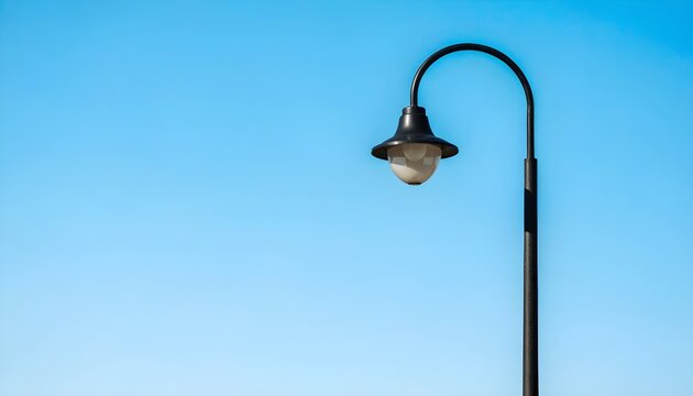 Classic Black Outdoor Wall Lantern Hanging on Clear Blue Sky Background Minimalist Style
