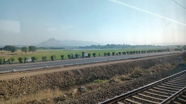 Landscape View of Mountains With Road and Railway Track