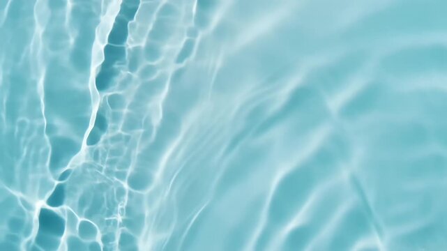 Calm turquoise pool water gleams with reflected sunlight, creating wavy bands of light on a smooth surface; translucent ripples swirl softly, inviting a quiet moment of cool refreshment and tranquil