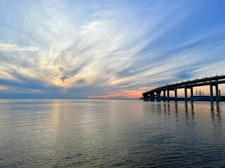 Obraz premium impressive huge bridge in the sunset sea horizon, fantastic sea horizon