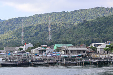Karimunjawa jepara coastline with floating fish farm and traditional wooden stilt houses in Indonesia. © Faris Fitrianto