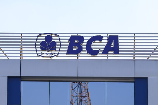 The official logo and building signage of Bank Central Asia (BCA), one of the largest private banks in Indonesia, mounted on top of a branch office building under a clear blue sky.