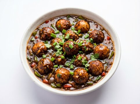 Appetizing veg manchurian gravy with green onions in a white bowl, shot in bright studio light against a clean backdrop, perfect for Asian restaurant menus and food blog marketing.
