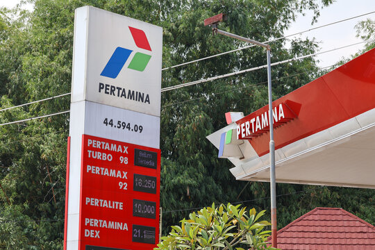 A close-up of a Pertamina gas station totem sign showing the company logo and fuel variant displays including Pertamax Turbo, Pertamax, Pertamina Dex, and Dexlite.