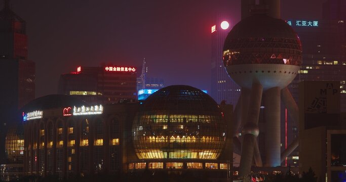 Stunning night view of Shanghai skyline showcasing vibrant neon lights.