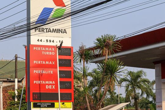A close-up of a Pertamina gas station totem sign showing the company logo and fuel variant displays including Pertamax Turbo, Pertamax, Pertamina Dex, and Dexlite.