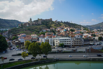 Panoramic vista of historic Tbilisi Old Town, Kura River, Narikala Fortress, and Metekhi Church, Georgia © Greggory Zzyzx