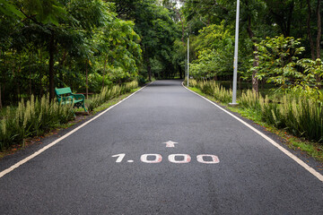 Fototapeta premium Empty jogging track with one thousand meters marker in a fitness park