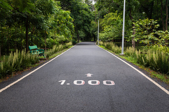 Empty jogging track with one thousand meters marker in a fitness park