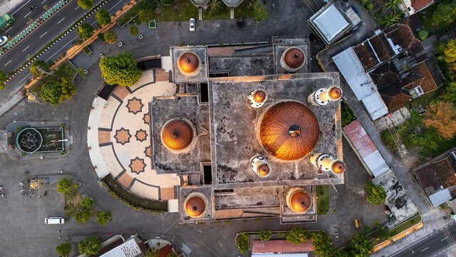 Aerial view of Al Aqsha Great Mosque Klaten with golden domes and geometric courtyard patterns in Kecamatan Klaten Utara, Jawa Tengah, Indonesia.